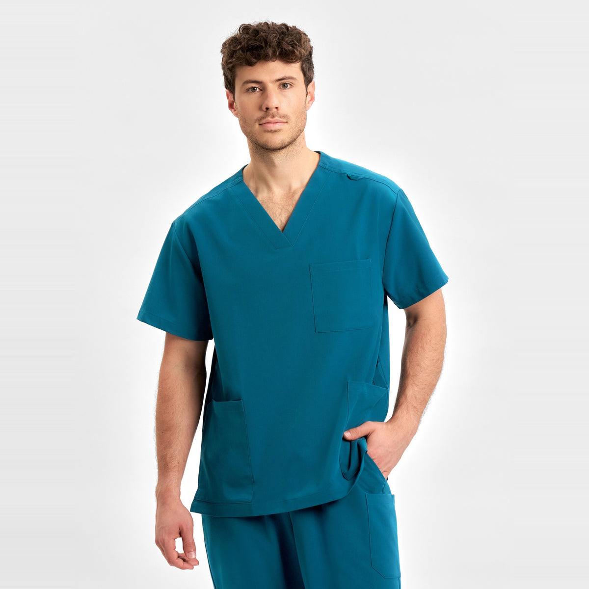 Inaura Pulse Unisex V-Neck Scrub Top CU544US in Caribbean Blue, worn by model