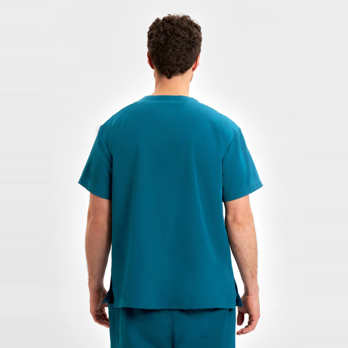 Inaura Pulse Unisex V-Neck Scrub Top CU544US in Caribbean Blue, worn by model, view 5