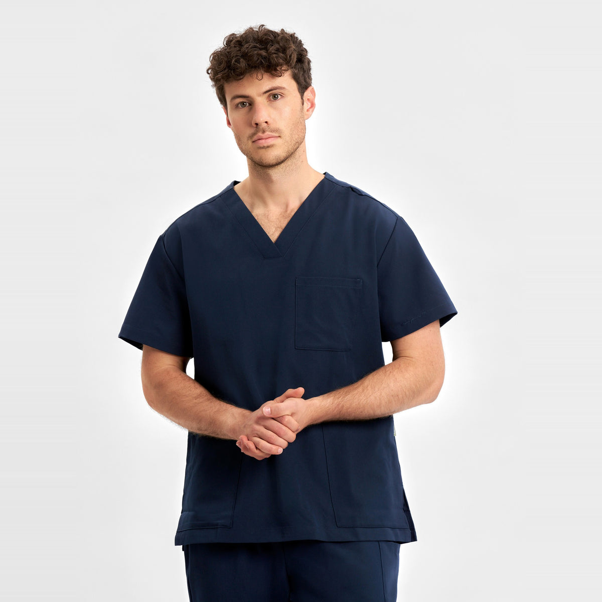 Inaura Pulse Unisex V-Neck Scrub Top CU544US in Midnight Navy, worn by model