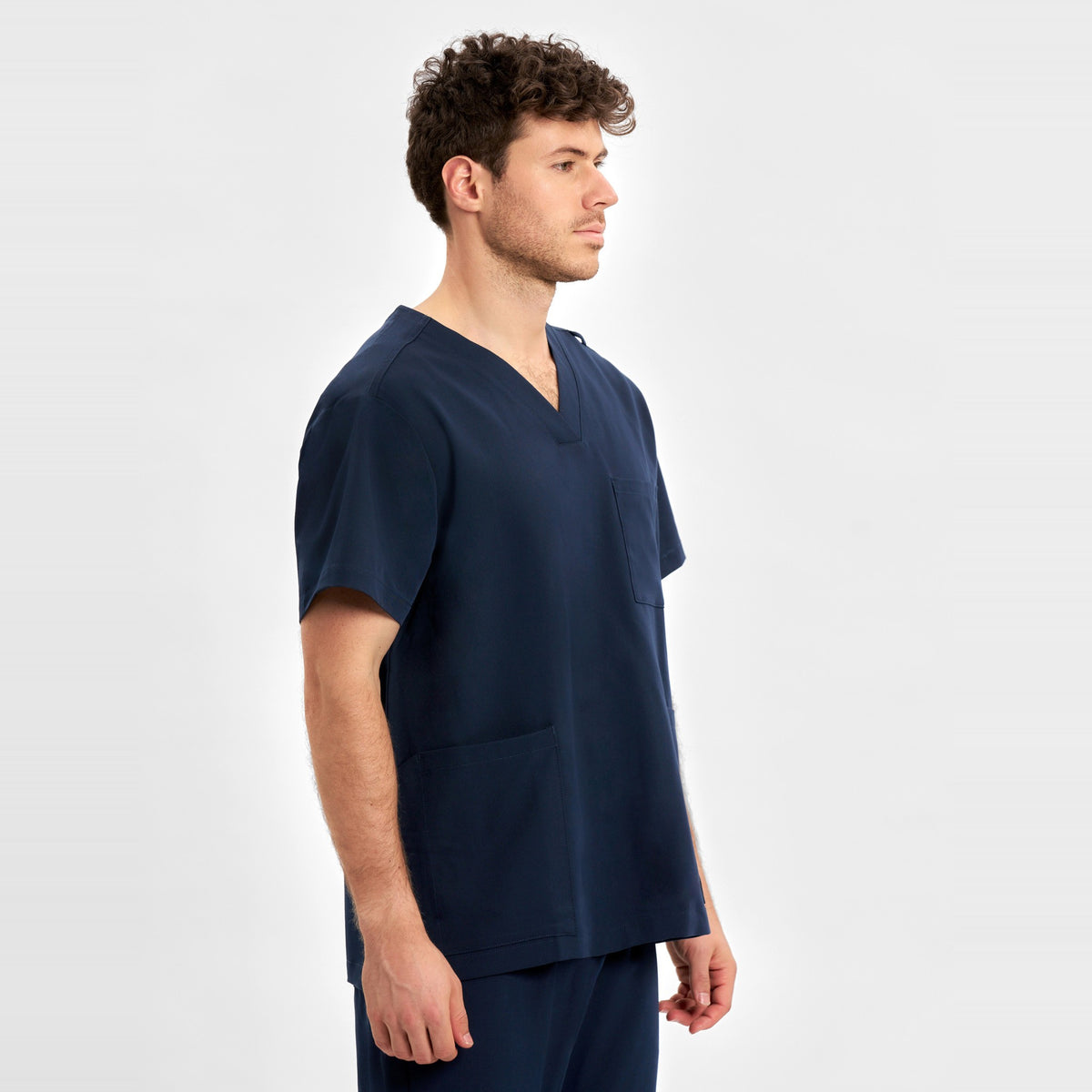 Inaura Pulse Unisex V-Neck Scrub Top CU544US in Midnight Navy, worn by model, view 3