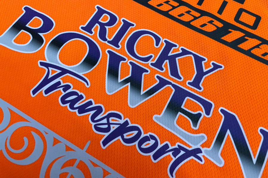 Close-up of a full-colour DTF print reading Ricky Bowen Transport on an orange work garment