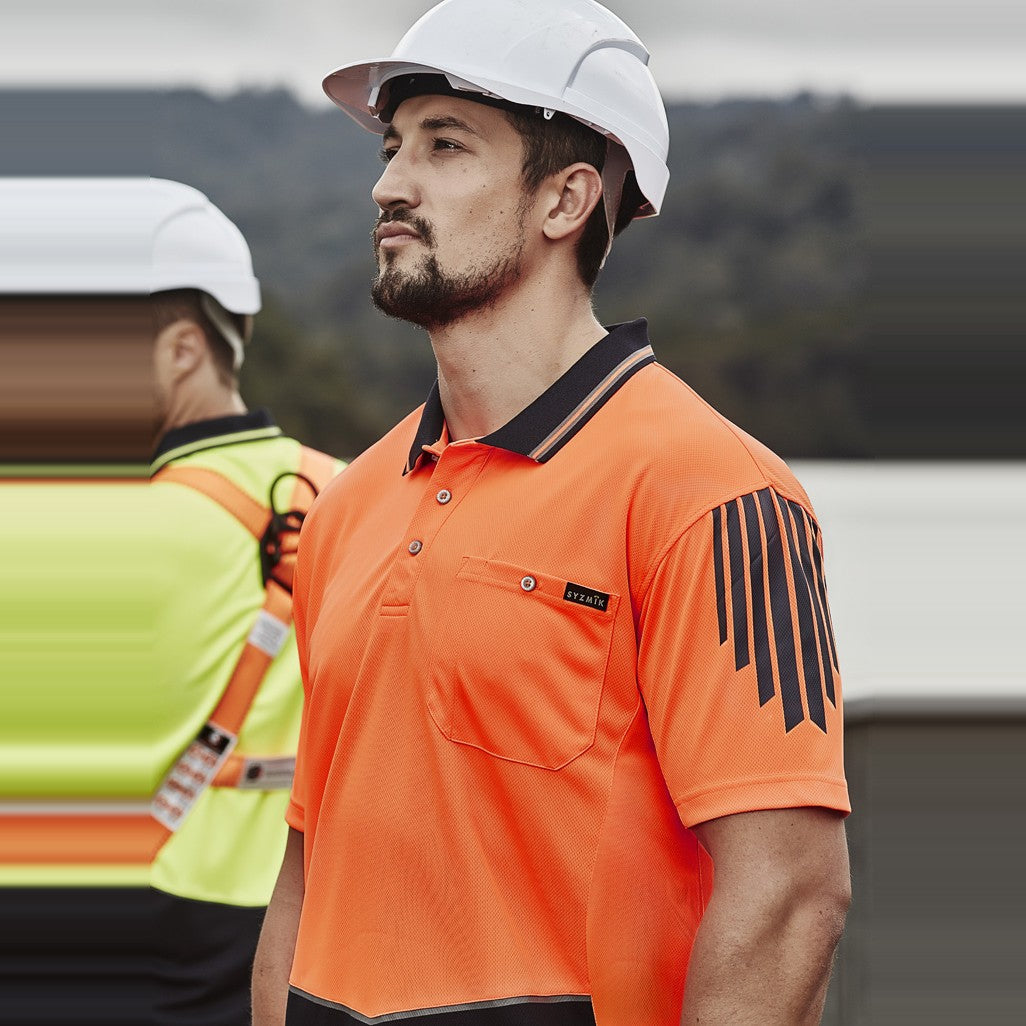 Syzmik Mens Hi Vis Flux Short Sleeve Polo ZH315 in Orange/Navy, worn by model