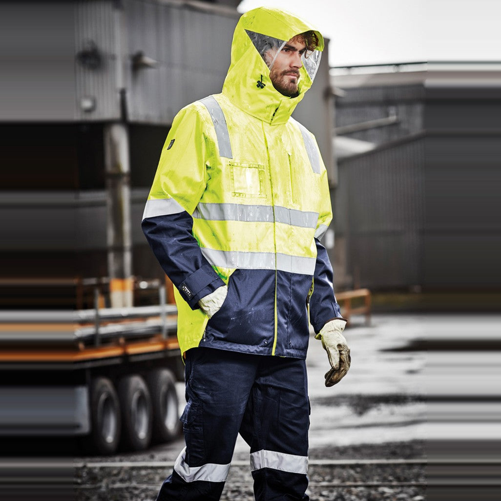 Syzmik Mens Hi Vis 4 In 1 Waterproof Jacket ZJ532 in Yellow/Navy, worn by model