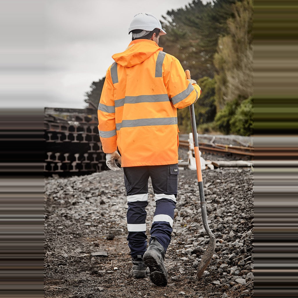 Syzmik Unisex Hi Vis VIC Rail 4 In 1 Waterproof Jacket ZJ580 in VIC Rail Orange, worn by model, view 4