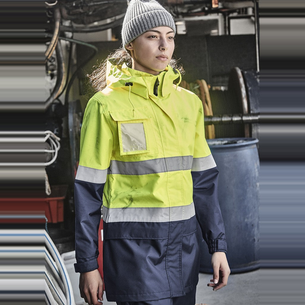 Syzmik Womens Hi Vis Ultralite Waterproof Jacket ZJ757 in Yellow/Navy, worn by model