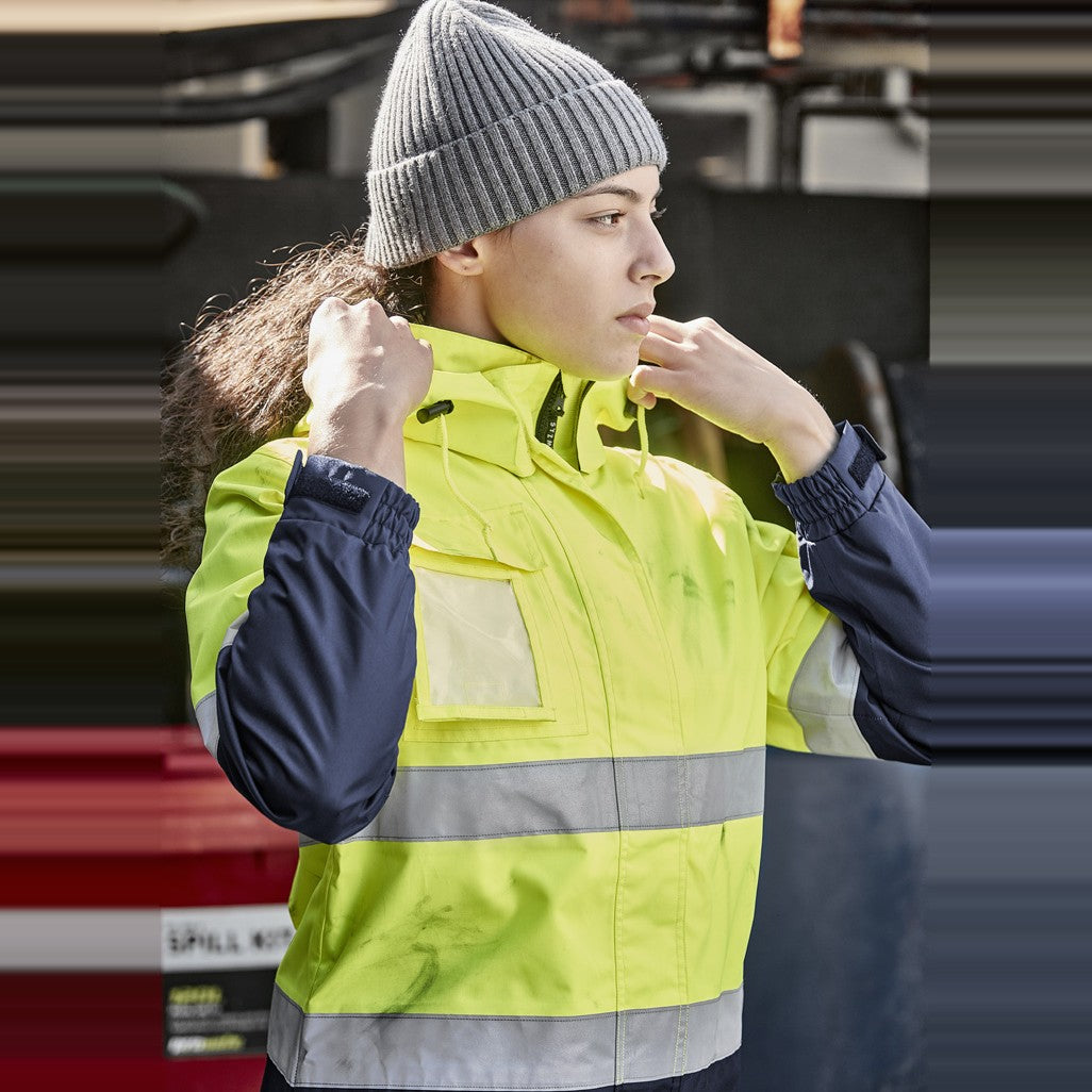 Syzmik Womens Hi Vis Ultralite Waterproof Jacket ZJ757 in Yellow/Navy, worn by model, view 2